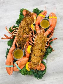 Color Picture of Two stuffed Lobsters with Lemon wedges & Butter 