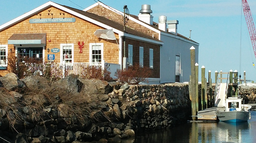 Color photo of Gardner's Wharf Seafood and dock and marina to the right